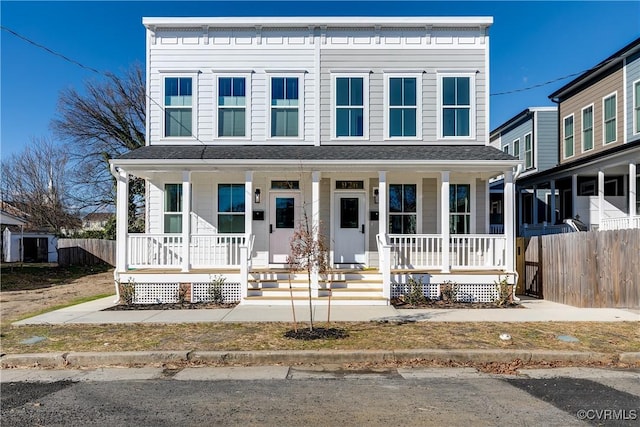 view of front of house featuring fence, a porch, and roof with shingles