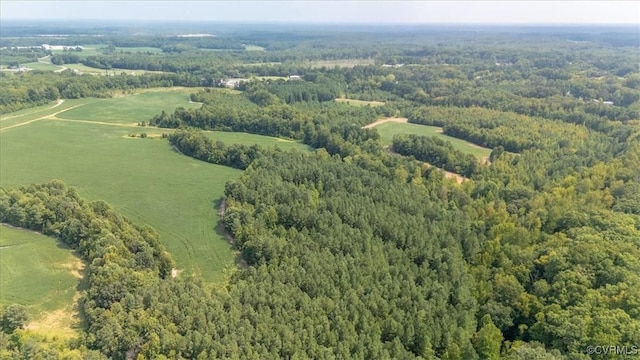 birds eye view of property featuring a view of trees