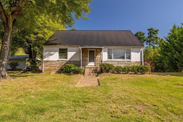 view of front facade featuring stone siding, stucco siding, metal roof, and a front lawn