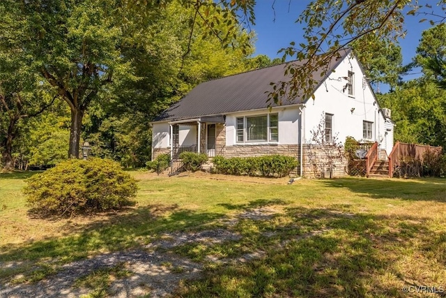 view of front of house featuring a front lawn, stone siding, and stucco siding