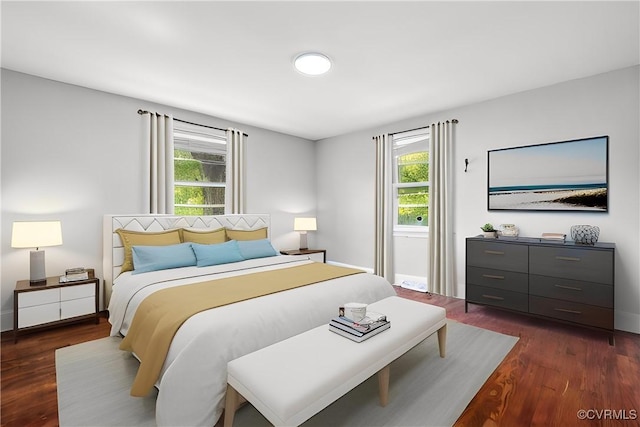 bedroom featuring dark wood-type flooring and baseboards