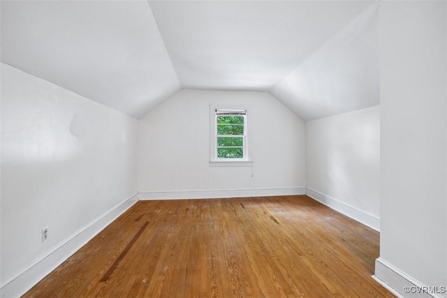 bonus room with lofted ceiling, wood finished floors, and baseboards