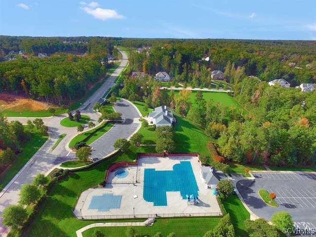 birds eye view of property with a wooded view