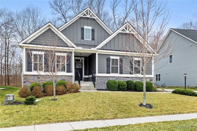 craftsman inspired home with stone siding, board and batten siding, and a front yard