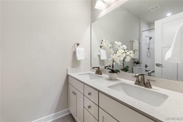 bathroom featuring tile patterned floors, visible vents, a shower, and a sink