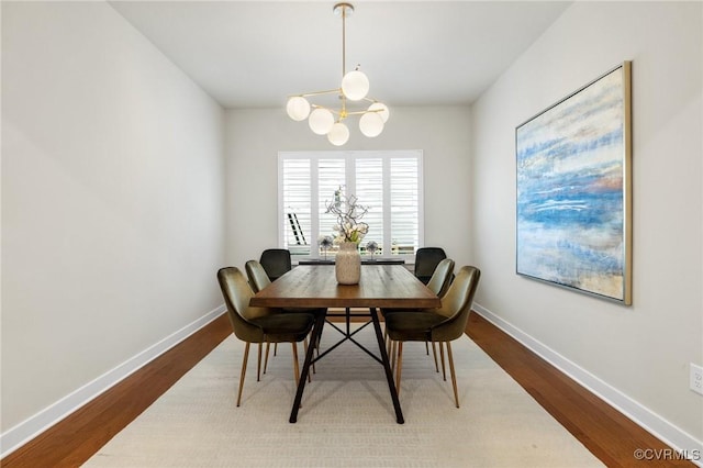 dining room with an inviting chandelier, wood finished floors, and baseboards