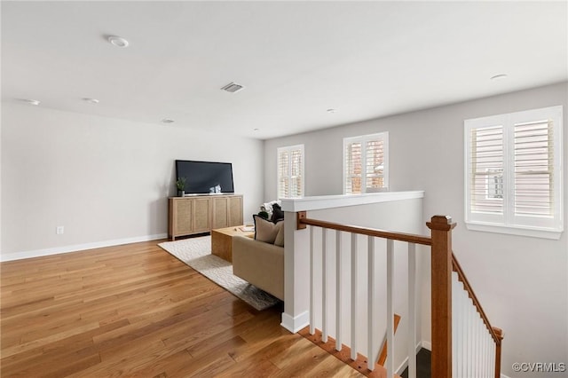 interior space with light wood-style flooring, baseboards, and visible vents