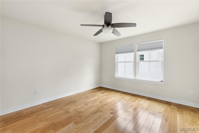 empty room featuring light wood-type flooring, baseboards, and a ceiling fan