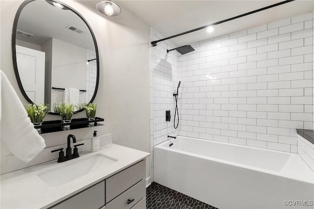 bathroom featuring tile patterned floors, visible vents, bathing tub / shower combination, and vanity