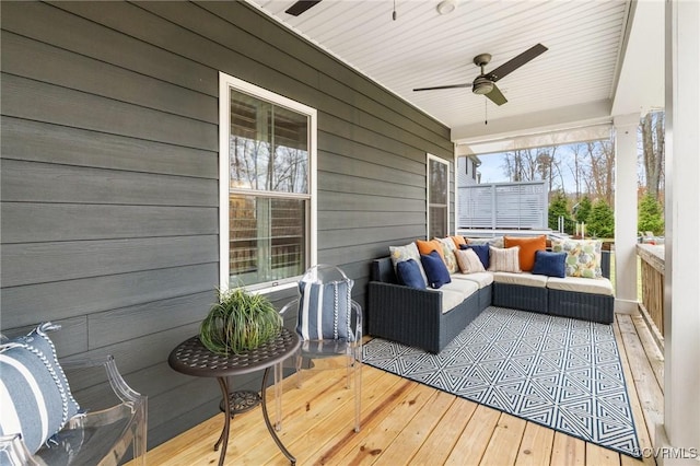 deck with an outdoor living space and ceiling fan