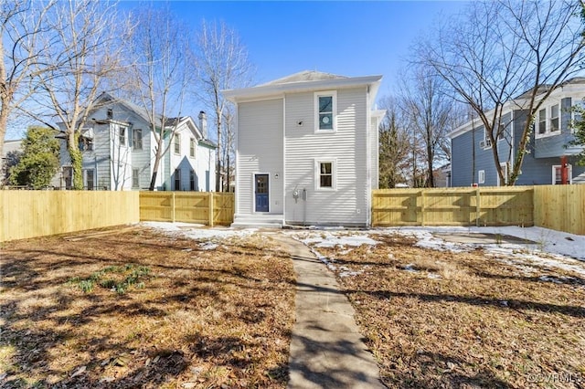 back of house featuring a fenced backyard and a residential view