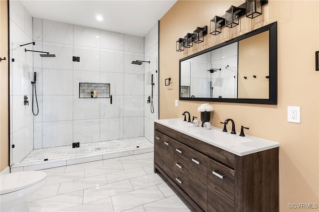 full bath featuring marble finish floor, double vanity, a sink, and a shower stall