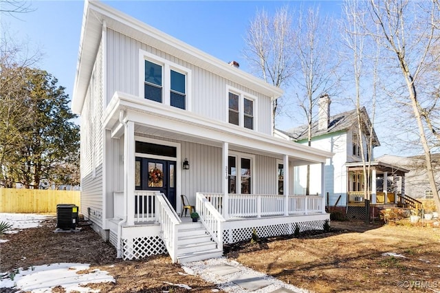 view of front of home with a porch, board and batten siding, and central air condition unit