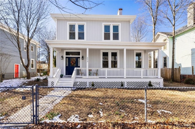 view of front facade featuring a porch, board and batten siding, a chimney, and a fenced front yard