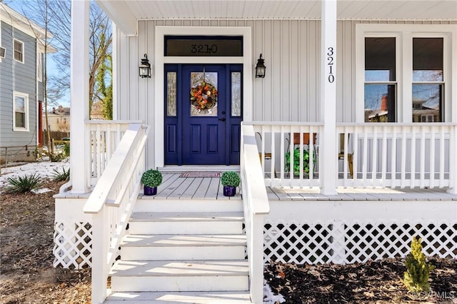 view of exterior entry with board and batten siding