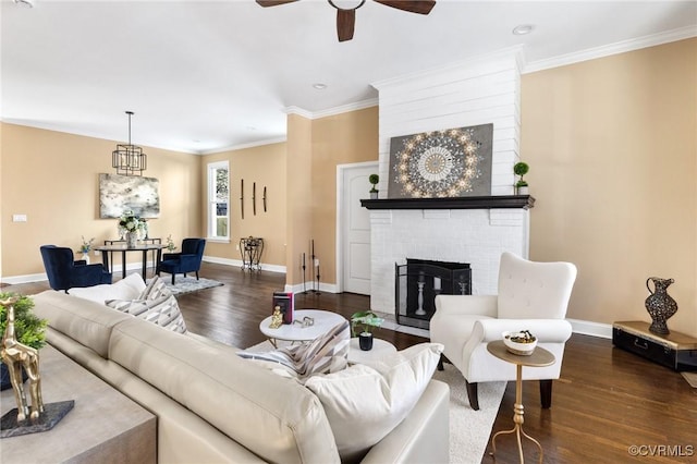 living room featuring ornamental molding, a fireplace, dark wood finished floors, and baseboards