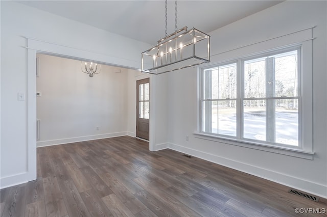 unfurnished dining area featuring dark wood-style floors, visible vents, and baseboards