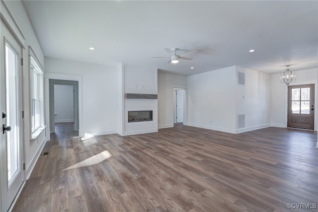 unfurnished living room featuring dark wood-style flooring, a fireplace, visible vents, and recessed lighting