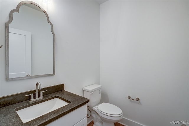 bathroom featuring toilet and vanity