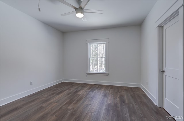 empty room featuring ceiling fan, baseboards, and dark wood-style flooring