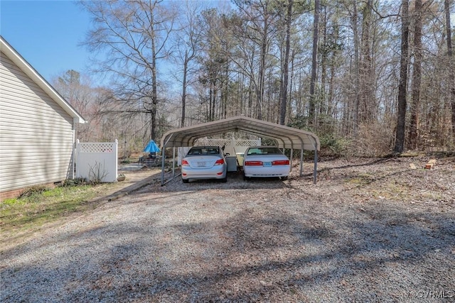 view of car parking featuring a detached carport and driveway