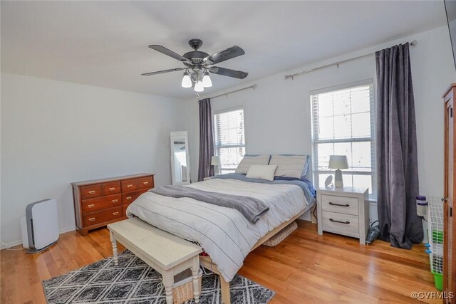 bedroom with light wood-type flooring and a ceiling fan