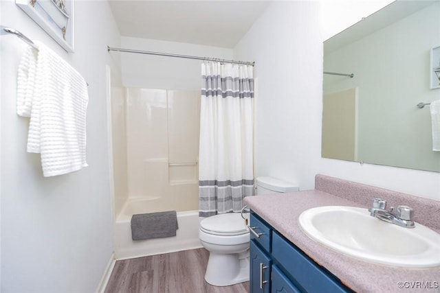 full bathroom with shower / bathtub combination with curtain, toilet, vanity, and wood finished floors