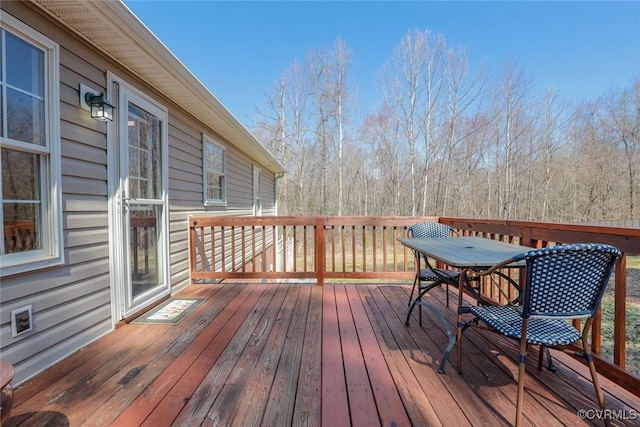 wooden terrace with outdoor dining area