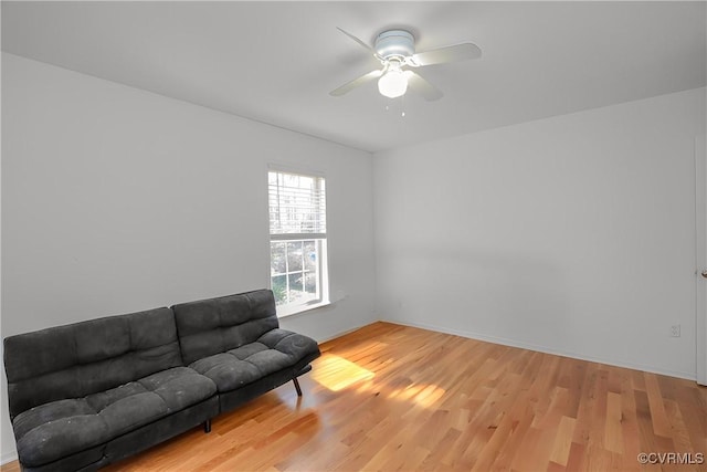 sitting room with ceiling fan and wood finished floors