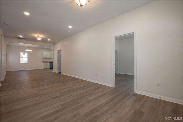 unfurnished living room featuring dark wood-style floors, visible vents, baseboards, and recessed lighting