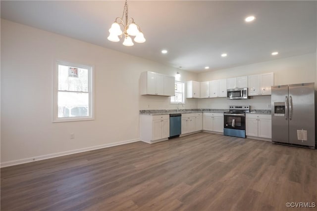 kitchen featuring appliances with stainless steel finishes, recessed lighting, dark wood-style flooring, and white cabinets