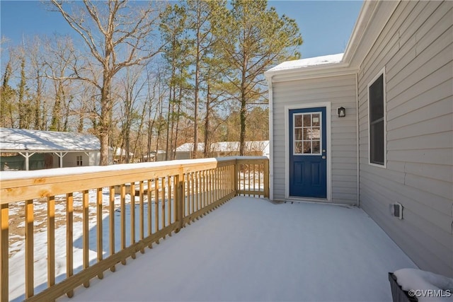 snow covered deck with fence