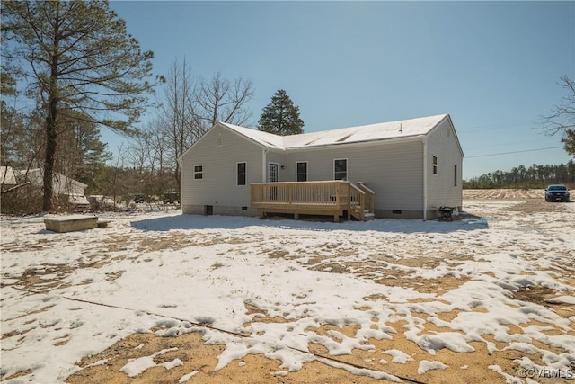 rear view of house with a deck and crawl space