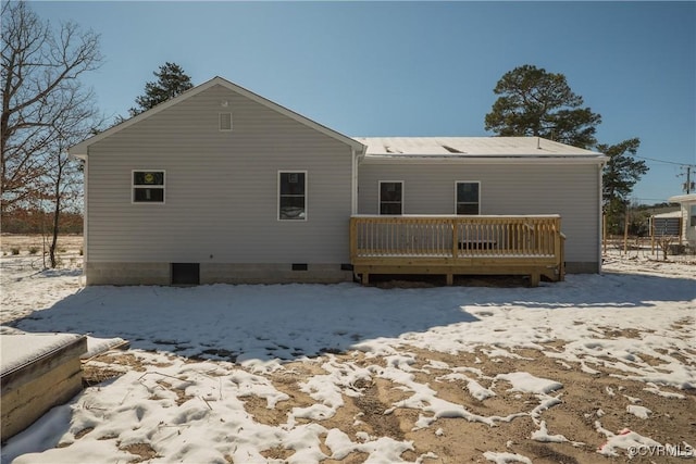 snow covered property with a deck and crawl space