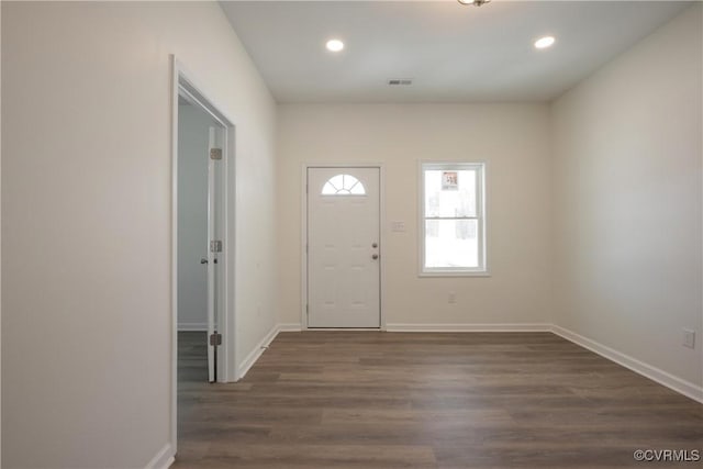 entrance foyer with dark wood-style floors, recessed lighting, visible vents, and baseboards