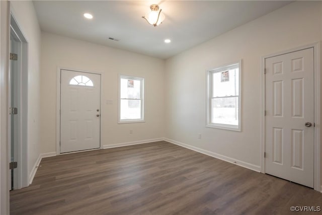 entryway featuring visible vents, dark wood finished floors, a wealth of natural light, and baseboards