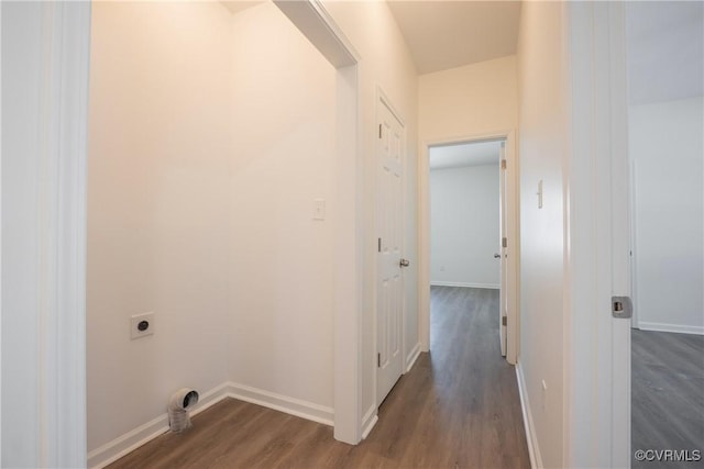 hall featuring baseboards and dark wood-type flooring