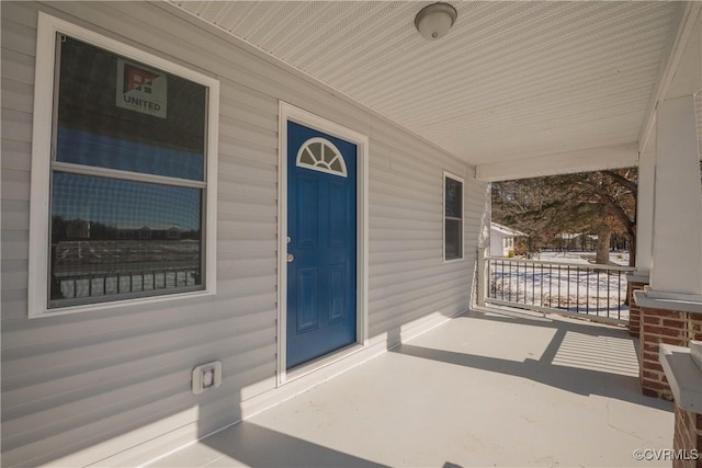 view of exterior entry featuring a porch