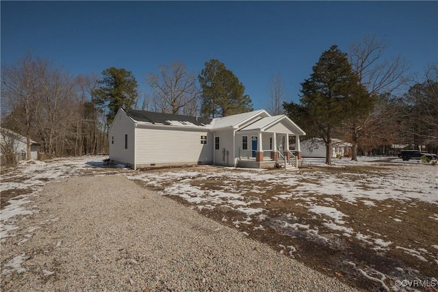 view of front of home featuring crawl space, covered porch, and driveway