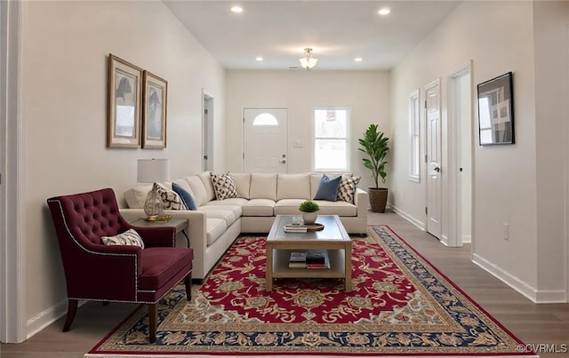 living room with baseboards, wood finished floors, and recessed lighting