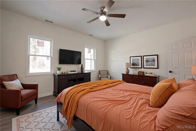 bedroom featuring a ceiling fan, baseboards, visible vents, and light wood finished floors