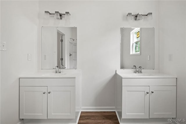 9214 River Rd, Chesterfield, VA 23803 - bathroom featuring two vanities and wood finished floors