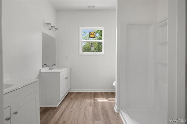 9214 River Rd, Chesterfield, VA 23803 - bathroom featuring two vanities, wood finished floors, and a shower