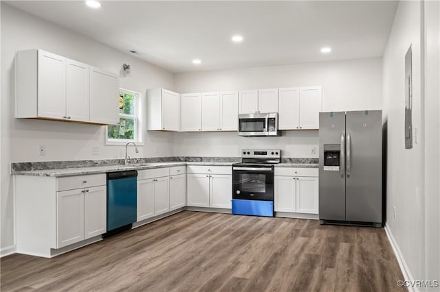 9214 River Rd, Chesterfield, VA 23803 - kitchen with stainless steel appliances, wood finished floors, white cabinetry, recessed lighting, and light stone countertops