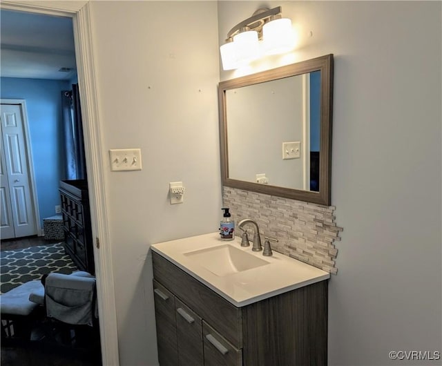 bathroom with decorative backsplash and vanity