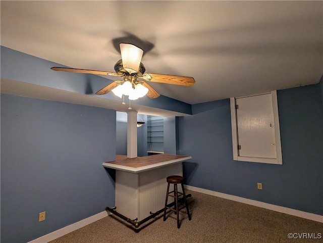 interior space with ceiling fan, a dry bar, and baseboards