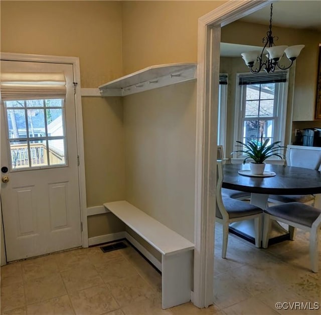 mudroom with baseboards, visible vents, and a chandelier