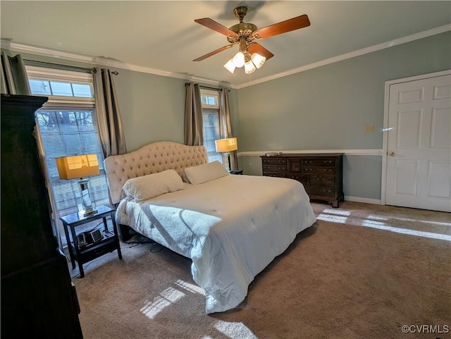 carpeted bedroom with baseboards, ornamental molding, and a ceiling fan