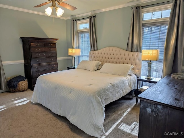 bedroom featuring carpet flooring, a ceiling fan, and crown molding