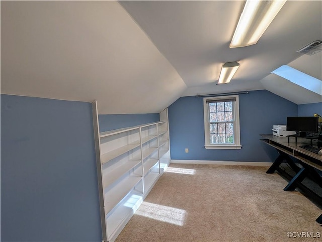 carpeted home office with visible vents, baseboards, and vaulted ceiling